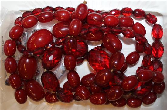 Two cherry amberoid necklaces and 2 pairs of earrings.